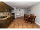 Basement kitchen with granite countertops, cabinetry, stainless appliances, and adjacent dining area at 8601 Flint Hill Rd, Douglasville, GA 30135