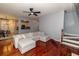 Bright, open living room featuring hardwood floors, a sectional sofa, and view to the kitchen at 8601 Flint Hill Rd, Douglasville, GA 30135