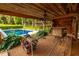 View of the pool from the patio with a ceiling fan and an outdoor kitchen at 8601 Flint Hill Rd, Douglasville, GA 30135
