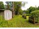 A rustic shed nestled in the backyard complements the natural surroundings and provides useful storage at 8601 Flint Hill Rd, Douglasville, GA 30135