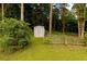 A backyard shed with a quaint fence blends into the natural landscape, offering practical storage at 8601 Flint Hill Rd, Douglasville, GA 30135
