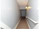 Staircase with painted grey walls and natural colored stairs and handrail at 8601 Flint Hill Rd, Douglasville, GA 30135