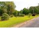 Expansive green yard leading to the beautiful home, offering plenty of space and a serene setting at 8601 Flint Hill Rd, Douglasville, GA 30135