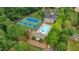Birds eye view of tennis courts, pool and clubhouse surrounded by trees at 1029 Harvest Brook Dr, Lawrenceville, GA 30043