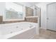 Bathroom featuring a large jacuzzi tub and separate walk-in shower at 1029 Harvest Brook Dr, Lawrenceville, GA 30043