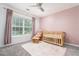 Charming Bedroom with a crib, rocking chair, and soft pink accents at 1029 Harvest Brook Dr, Lawrenceville, GA 30043
