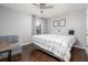Bedroom featuring hardwood floors, a ceiling fan, and a comfortable bed at 1029 Harvest Brook Dr, Lawrenceville, GA 30043