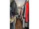 Walk-in closet with wood floors, rods, and shelves for organized storage at 1029 Harvest Brook Dr, Lawrenceville, GA 30043
