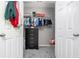 Organized walk-in closet with hanging racks, storage, and a chest of drawers at 1029 Harvest Brook Dr, Lawrenceville, GA 30043
