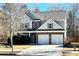 Charming two-story home featuring a brick facade, two-car garage, and meticulously maintained landscaping at 1029 Harvest Brook Dr, Lawrenceville, GA 30043