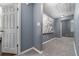 Hallway with gray walls, white trim, carpet floors, and wall art at 1029 Harvest Brook Dr, Lawrenceville, GA 30043