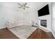 Cozy living room featuring a fireplace, a ceiling fan, and comfortable seating at 1029 Harvest Brook Dr, Lawrenceville, GA 30043