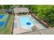 Aerial view of a community pool with lounge chairs and a mushroom water feature, surrounded by trees and a clubhouse at 1029 Harvest Brook Dr, Lawrenceville, GA 30043