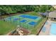 Aerial view of blue and green tennis and pickleball courts with playground and pool at 1029 Harvest Brook Dr, Lawrenceville, GA 30043