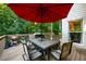 Open wood deck with patio table, umbrella, grill and surrounding trees at 1304 Carrington Way, Lawrenceville, GA 30044