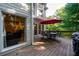 Outdoor living space with wood deck, patio table, chairs, and red umbrella at 1304 Carrington Way, Lawrenceville, GA 30044
