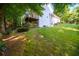 View of the home's exterior with a spacious lawn, mature trees, and a large deck, creating an inviting outdoor space at 1304 Carrington Way, Lawrenceville, GA 30044