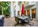 Backyard view showcasing patio table, umbrella, grill, and mature trees at 1304 Carrington Way, Lawrenceville, GA 30044