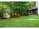 Spacious backyard featuring a well-maintained lawn, a deck area, and a charming storage shed at 1304 Carrington Way, Lawrenceville, GA 30044