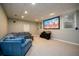 Finished basement featuring a cozy blue sectional and large screen projector, perfect for entertainment at 1304 Carrington Way, Lawrenceville, GA 30044