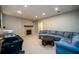 Basement Gathering room with fireplace and blue sectional sofa at 1304 Carrington Way, Lawrenceville, GA 30044