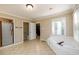 Spacious bathroom featuring a shower, soaking tub, and tile floors, offering a luxurious retreat at 1304 Carrington Way, Lawrenceville, GA 30044