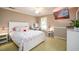 Bright bedroom with a large bed, TV, white trim, and a makeup desk, providing a comfortable and stylish space at 1304 Carrington Way, Lawrenceville, GA 30044