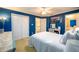 Spacious bedroom with blue walls, white trim, and ample closet space, offering a comfortable retreat at 1304 Carrington Way, Lawrenceville, GA 30044