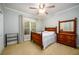 Cozy bedroom with a wooden bed frame, soft carpet, and ample natural light at 1304 Carrington Way, Lawrenceville, GA 30044