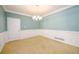 Bright and elegant dining room with classic wainscotting and stylish chandelier at 1304 Carrington Way, Lawrenceville, GA 30044
