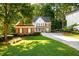 Beautiful brick home featuring a well-maintained lawn and mature trees at 1304 Carrington Way, Lawrenceville, GA 30044