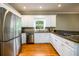 Modern kitchen with stainless steel appliances, granite countertops, and white cabinets at 1304 Carrington Way, Lawrenceville, GA 30044