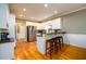 A spacious kitchen with stainless steel appliances, wooden floors, and a convenient breakfast bar at 1304 Carrington Way, Lawrenceville, GA 30044