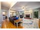 A spacious living room featuring hardwood floors, a brick fireplace, and large windows at 1304 Carrington Way, Lawrenceville, GA 30044