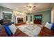 Inviting living room featuring a brick fireplace, ceiling fan, and a large decorative rug at 1304 Carrington Way, Lawrenceville, GA 30044