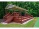 Community pavilion featuring wooden stairs and railings set in a green lawn surrounded by trees at 1304 Carrington Way, Lawrenceville, GA 30044