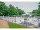 Community pool area with lounge chairs, shade, and fenced perimeter, ensuring safety and relaxation at 1304 Carrington Way, Lawrenceville, GA 30044