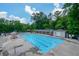 Community pool featuring a large swimming area, lounge chairs, and shaded seating for residents to enjoy at 1304 Carrington Way, Lawrenceville, GA 30044