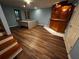 Finished basement with wood-look floors, wood-paneled bar, and an office area with a workstation at 351 Oak Harbor Trl, Marietta, GA 30066