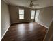 Bedroom featuring laminate floors, two windows, and a door leading to an adjacent space at 351 Oak Harbor Trl, Marietta, GA 30066