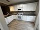 Modern kitchen featuring white cabinets, granite countertops, stainless steel appliances, and wood-look floors at 351 Oak Harbor Trl, Marietta, GA 30066