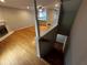 Open-concept living room with hardwood floors, a fireplace, and stairs leading to the downstairs at 351 Oak Harbor Trl, Marietta, GA 30066