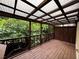 Enclosed wood patio with open railings and corrugated rooftop provides ample outdoor space and sunlight at 351 Oak Harbor Trl, Marietta, GA 30066