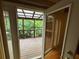 Covered patio with wood decking, open railings, and outdoor views framed by an open doorway at 351 Oak Harbor Trl, Marietta, GA 30066