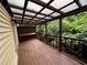 Enclosed wood patio with open railings and corrugated rooftop provides ample outdoor space at 351 Oak Harbor Trl, Marietta, GA 30066