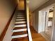 View of the staircase with wood steps and white risers leading to the second floor and the updated kitchen visible at 351 Oak Harbor Trl, Marietta, GA 30066
