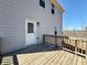 View of the back deck and exterior of the house with gray siding and a wood railing, perfect for enjoying outdoor living at 3836 Saddle Hill Way, Douglasville, GA 30135