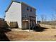 A home with a wooden deck overlooks a spacious backyard, enclosed by a wooden fence for privacy at 3836 Saddle Hill Way, Douglasville, GA 30135