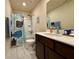 Well-lit bathroom features a shower and tub combo, whale-themed shower curtain and a modern vanity with a white countertop at 3836 Saddle Hill Way, Douglasville, GA 30135