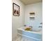Relaxing bathroom featuring a soaking tub, wooden accents, and minimalist decor, creating a serene atmosphere at 3836 Saddle Hill Way, Douglasville, GA 30135